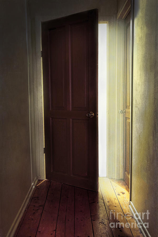 Old wooden door with light coming through doorway #1 Photograph by Sandra Cunningham