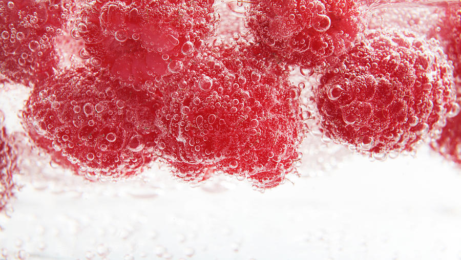 Raspberries In Sparkling Water #1 Photograph by Stock4b-rf