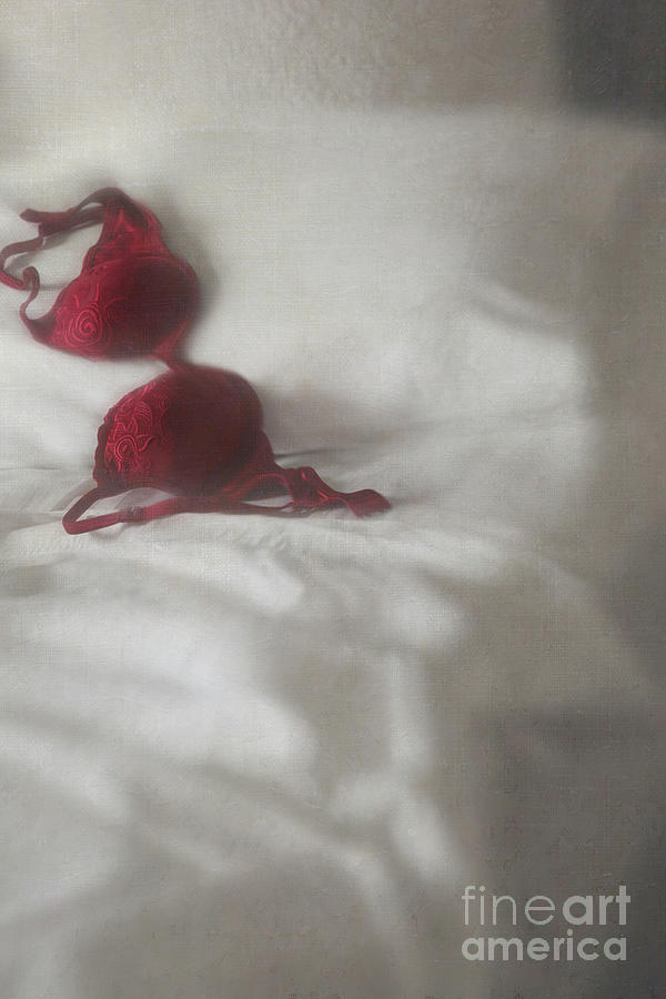 Red brassiere laying on bed #1 Photograph by Sandra Cunningham