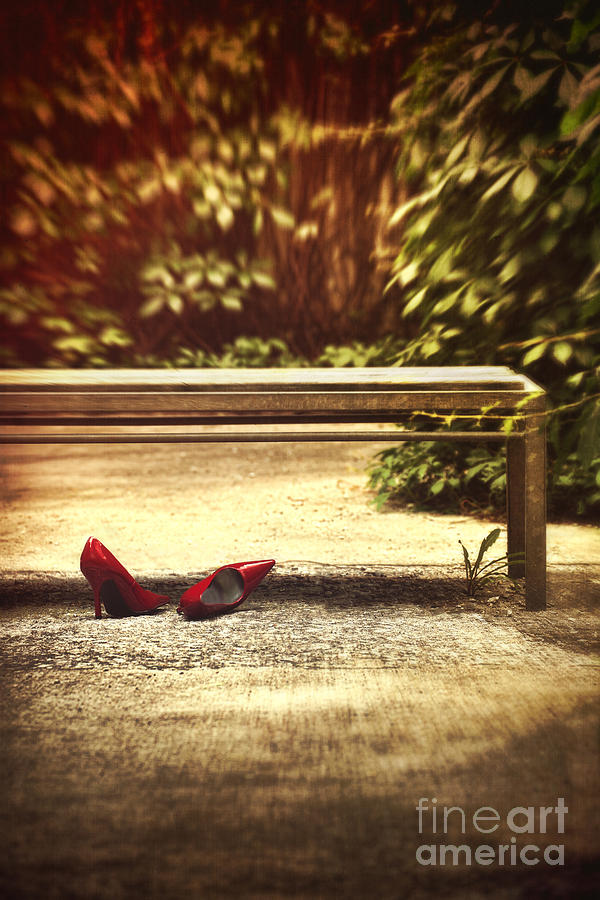 Red stiletto shoes left under a park bench #1 Photograph by Sandra Cunningham