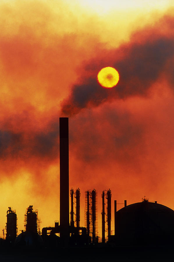 Aruba Photograph - Smoking Chimneys Of An Oil Refinery At Sunset #1 by David Nunuk