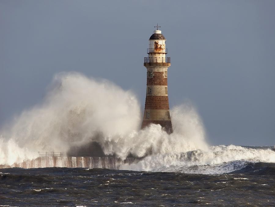 Lighthouse holding steadfast against waves