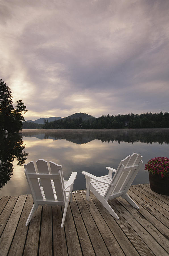 A Pair Of Adirondack Chairs On A Dock Photograph by 