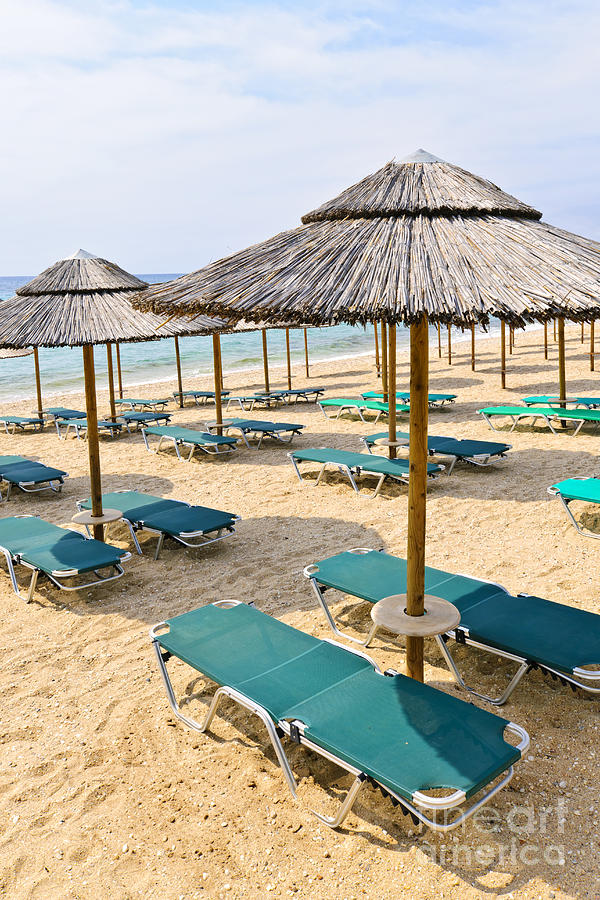 Beach umbrellas on sandy seashore 1 Photograph by Elena Elisseeva