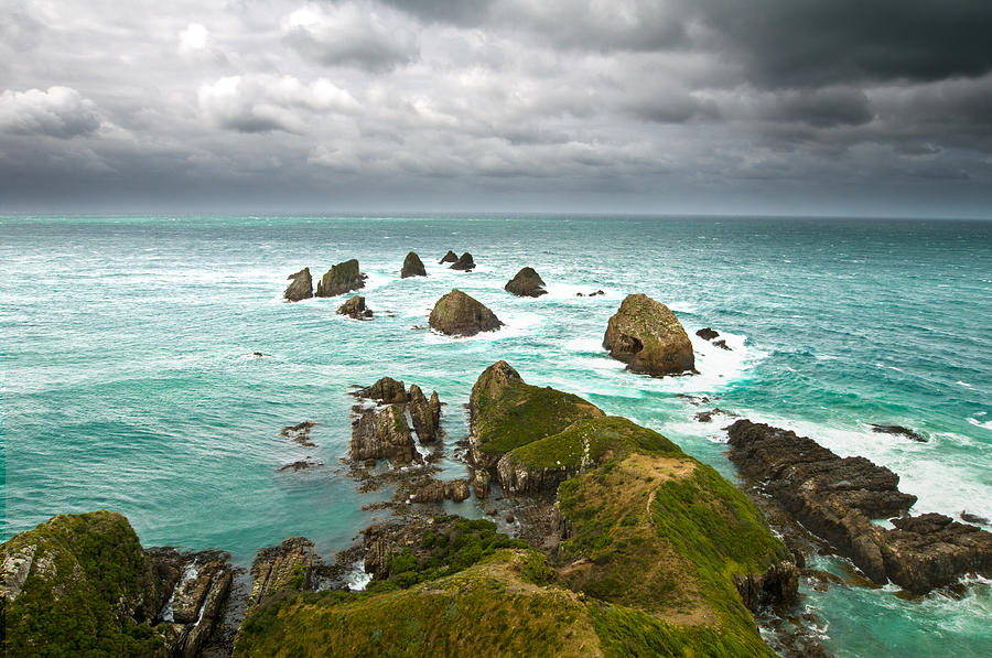 Cliffs under thunder clouds and turquoise ocean #2 Photograph by U Schade