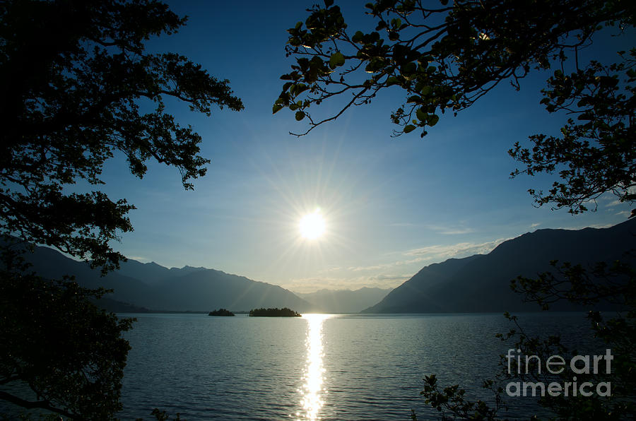 Nature Photograph - Sunshine over an alpine lake #2 by Mats Silvan