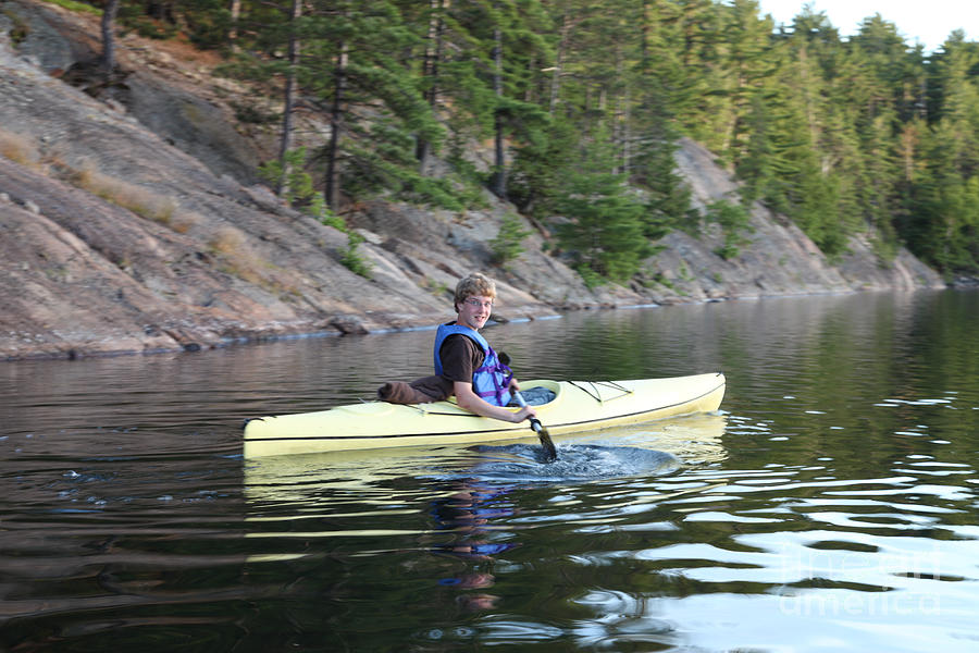 A Boy Kayaking Photograph by Ted Kinsman