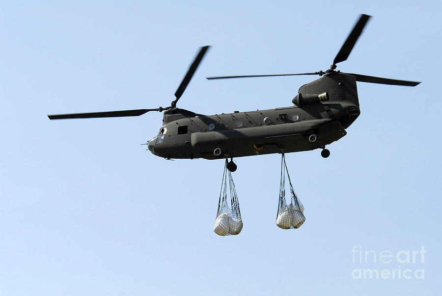 Transportation Photograph - A Ch-47 Chinook Carrying Sandbags by Stocktrek Images