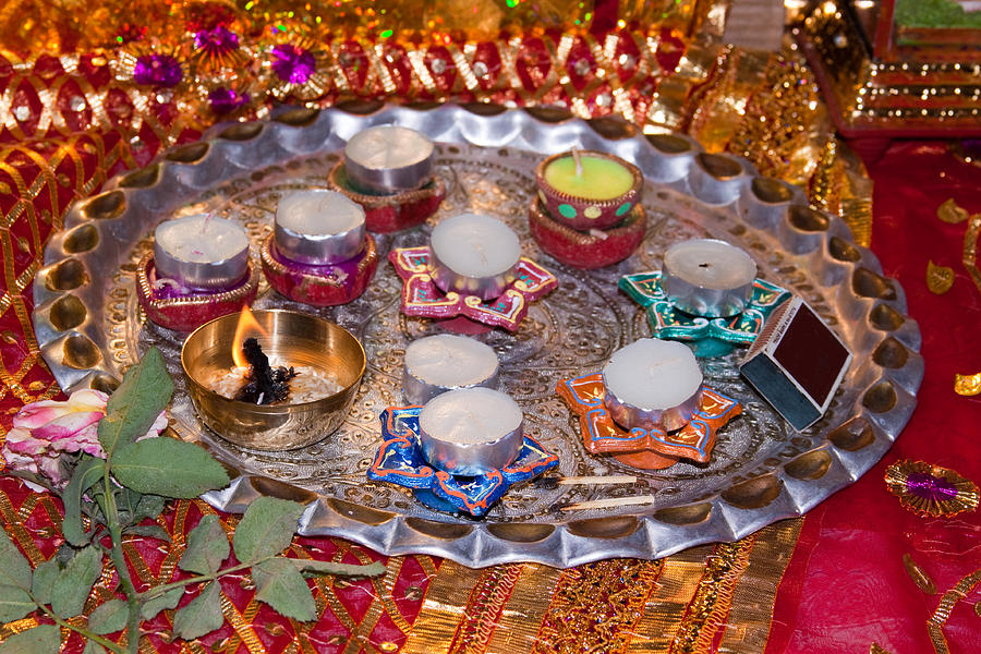 A decorated Hindu prayer thaali with wax candles oil lamps Photograph ...