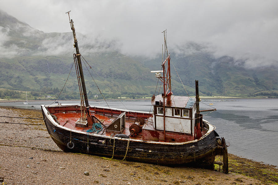 Beach Photograph - A Fishing Boat Abandoned On The Shore by John Short
