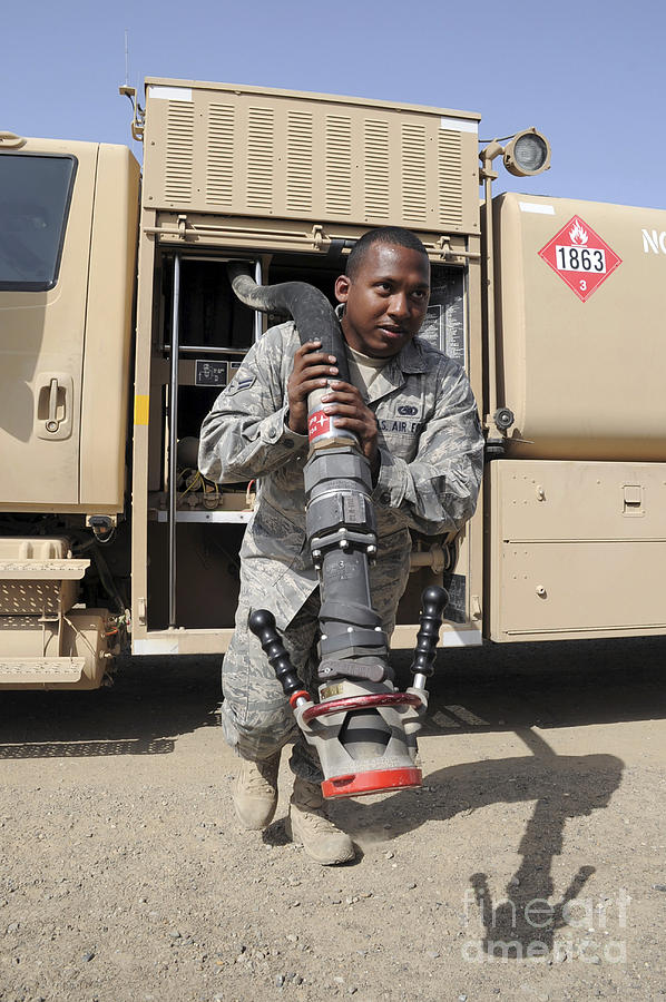 A Fuels Distribution Apprentice Pulls Photograph by Stocktrek Images