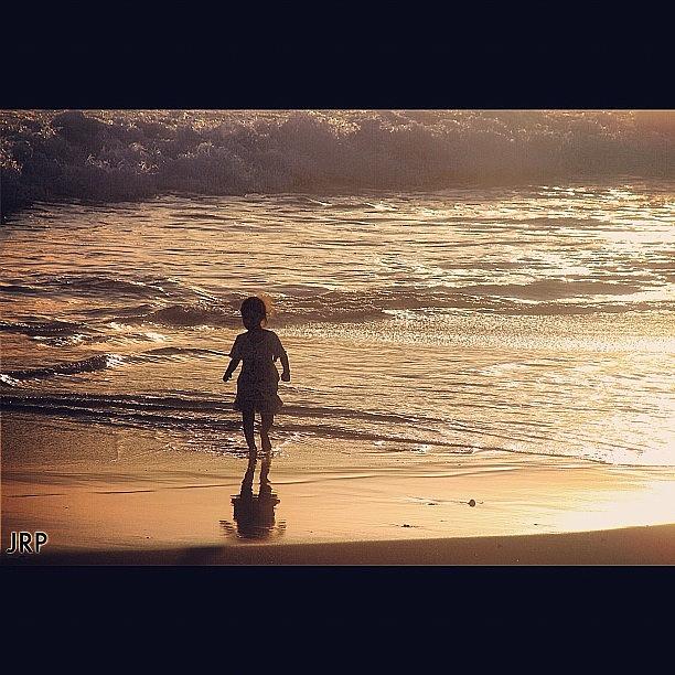 Sunset Photograph - A Little Girl Running From The Wave by Julianna Rivera-Perruccio