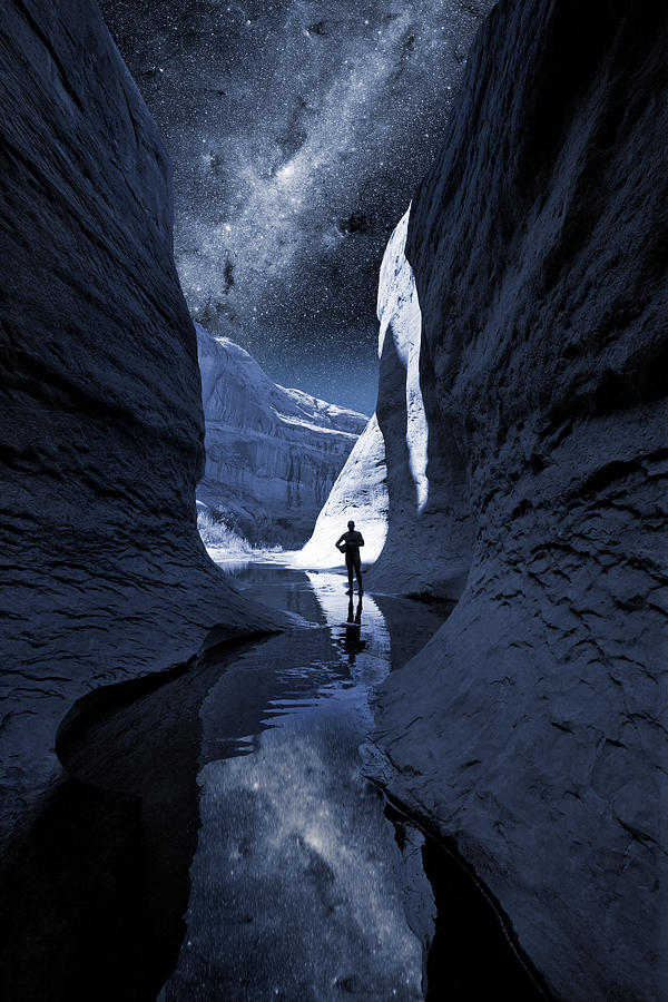 Nature Digital Art - A man hiking in a Lake Powel slot canyon at night with Milky Way by Bryan Allen