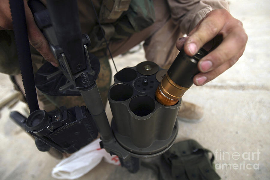 40mm Photograph - A Marine Loads 40 Mm Grenades by Stocktrek Images