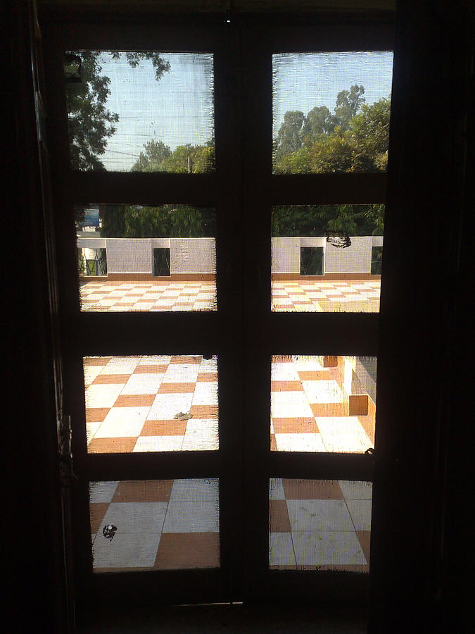 A meshed door opening to an open courtyard Photograph by Ashish Agarwal