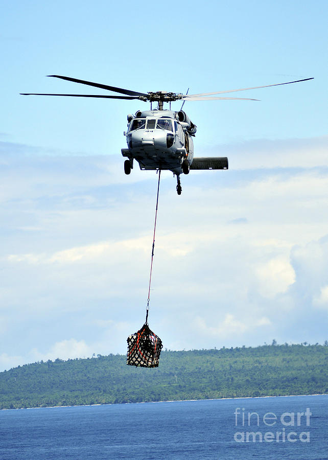 Transportation Photograph - A Mh-60 Knighthawk Carries Supplies by Stocktrek Images