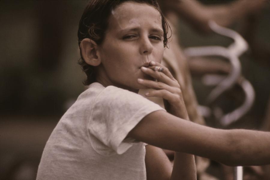Portrait Photograph - A Pre-teen Boy Smoking A Cigarette by Everett