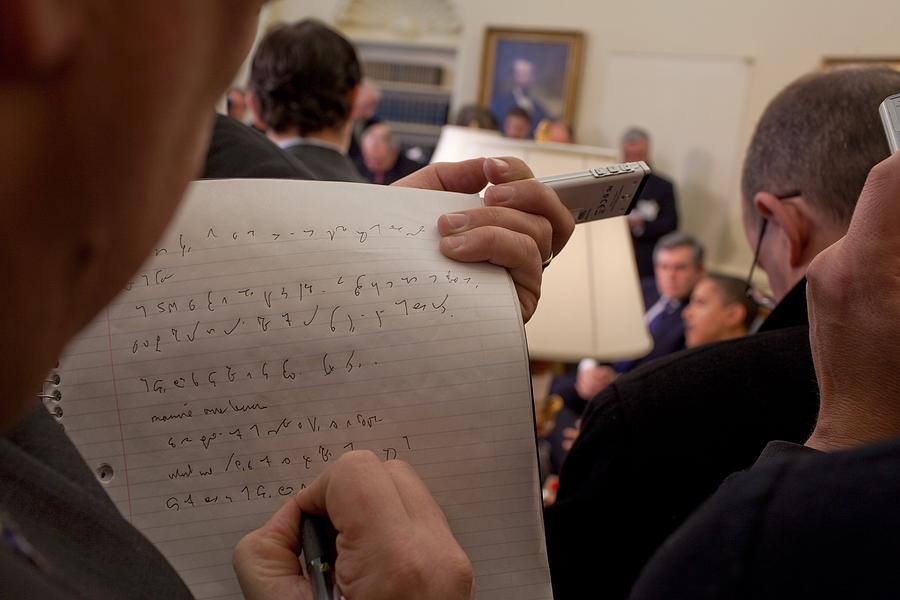 a-reporter-takes-shorthand-notes-while-photograph-by-everett