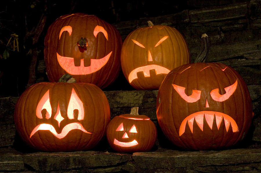 A Row Of Carved, Lit Pumpkins Photograph by Tim Laman