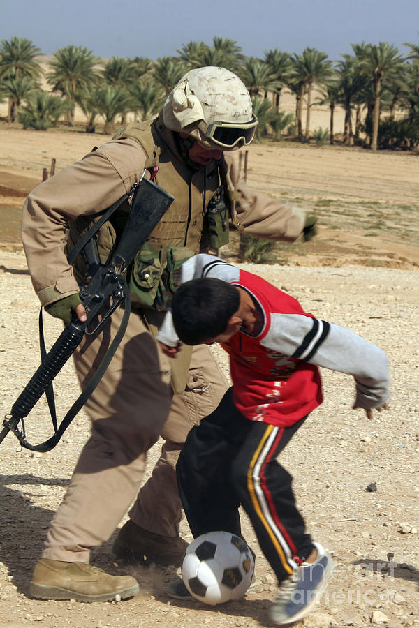 Soccer Photograph - A Soldier Plays Soccer With An Iraqi by Stocktrek Images