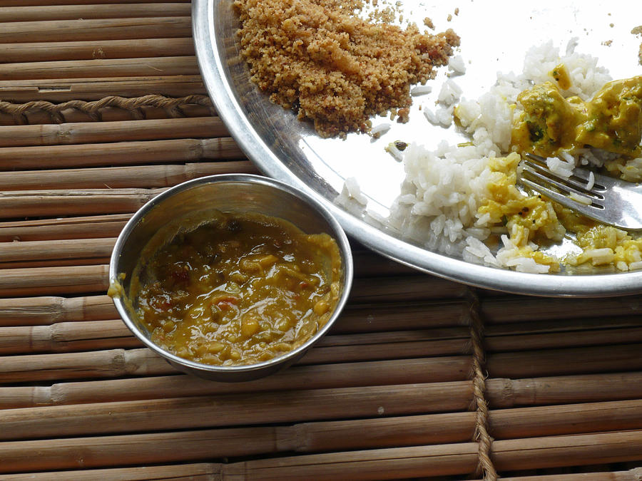 A typical plate of Indian Rajasthani food on a bamboo table Photograph by Ashish Agarwal
