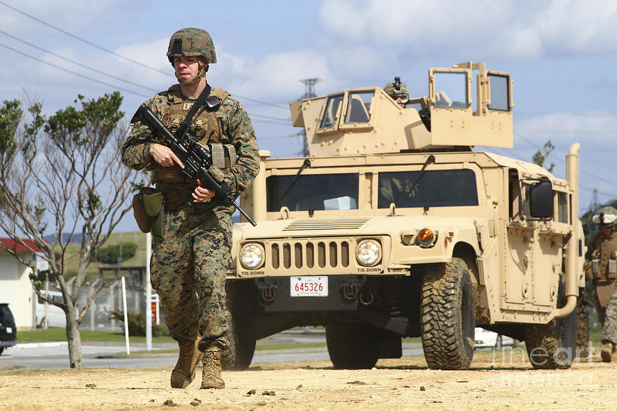 A U.s. Marine Guides A Humvee Photograph by Stocktrek Images