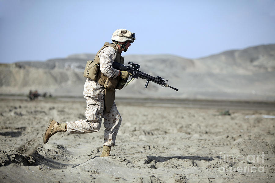 A U.s. Marines Runs Across The Beach Photograph by Stocktrek Images