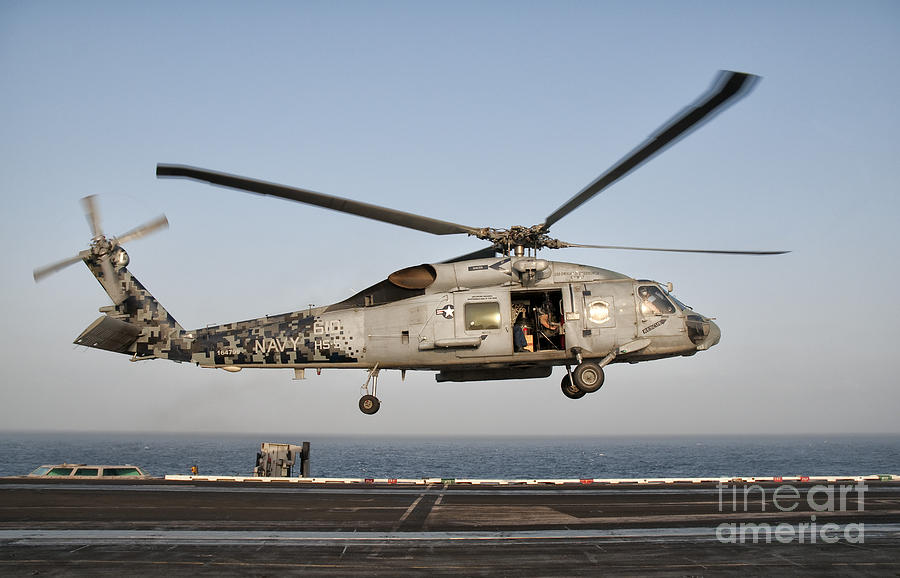 Transportation Photograph - A Us Navy Sh-60f Seahawk Hovers by Giovanni Colla