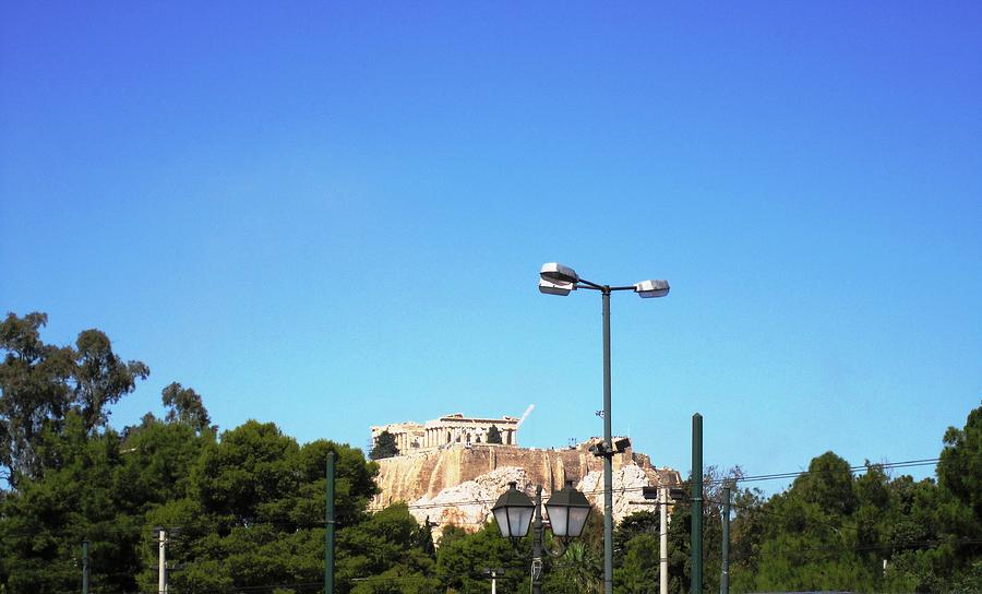 Acropolis Sits on the Hilltop in the Far Distance from the Street Lamp Post in Athens Greece Photograph by John Shiron