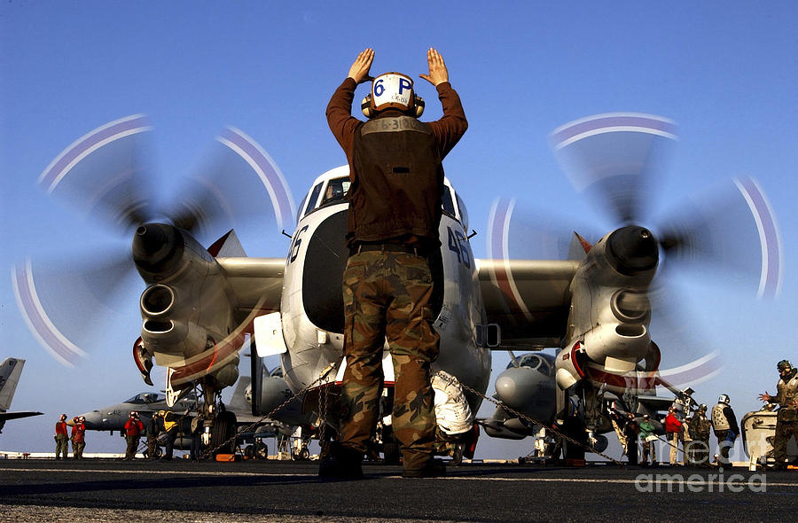 Airplane Photograph - Airmam Instructs The Pilots Of A C-2a by Stocktrek Images
