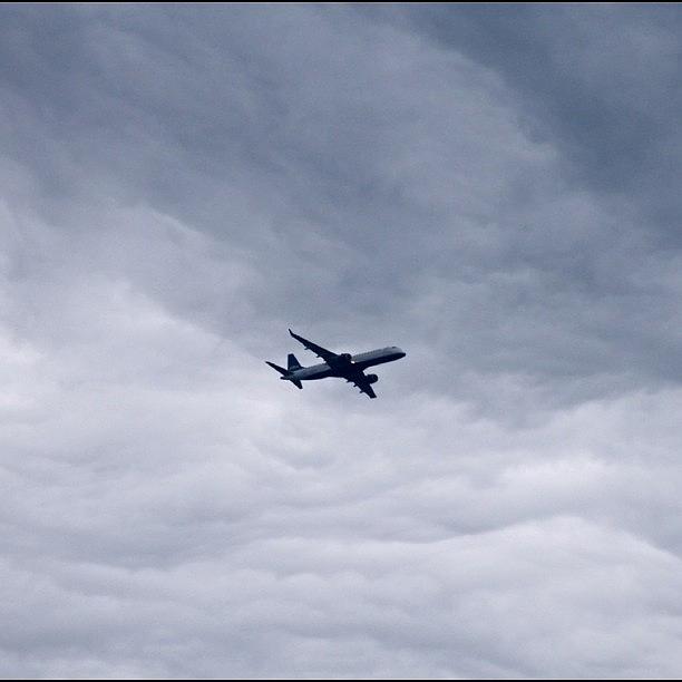 Airplane Photograph - Airplane and Storm Clouds by Justin Connor