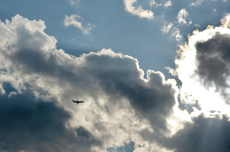 Airplane on a background of clouds Photograph by Michael Goyberg