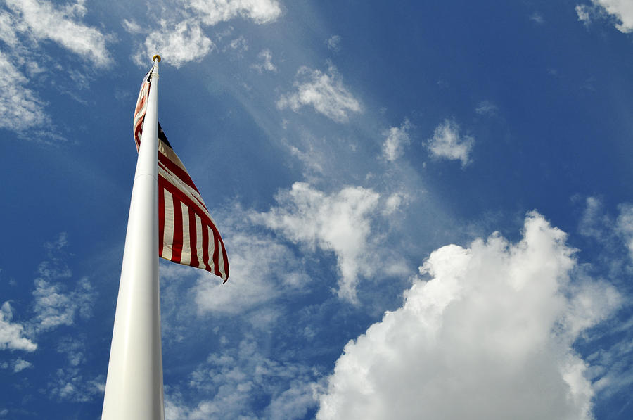 Flag Photograph - American Flag Against a Blue Sky From Low Angle by Evelyn Peyton