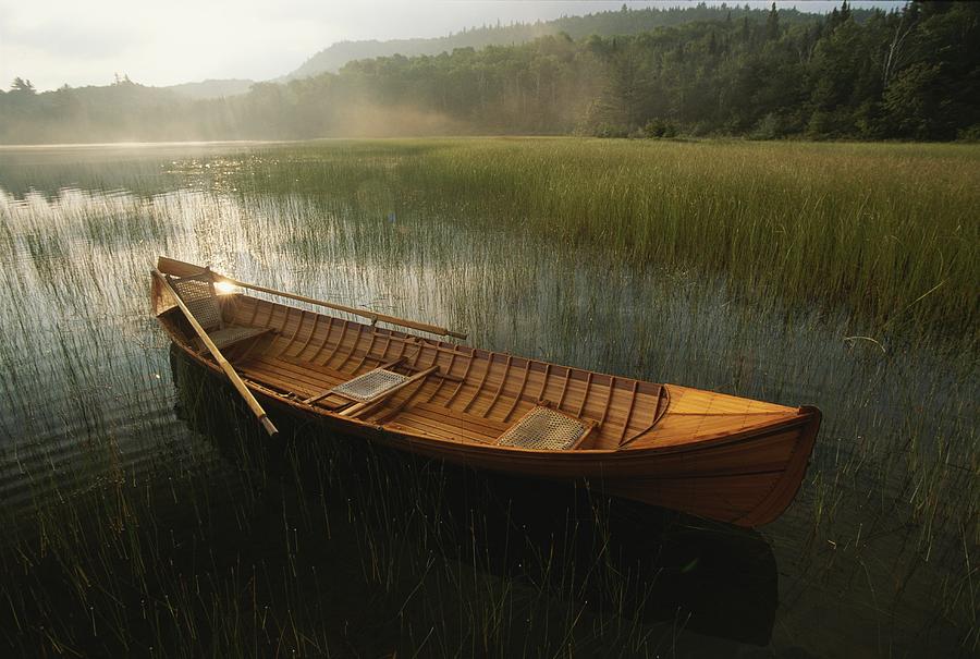 An Adirondack Guide Canoe Floating Photograph by Michael 