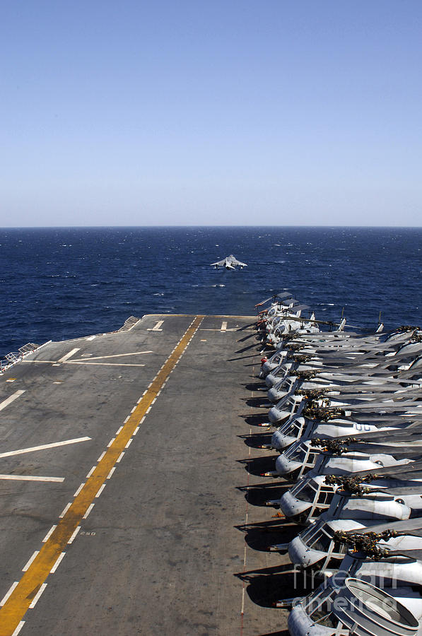An Av-8b Takes Off From The Flight Deck Photograph by Stocktrek Images