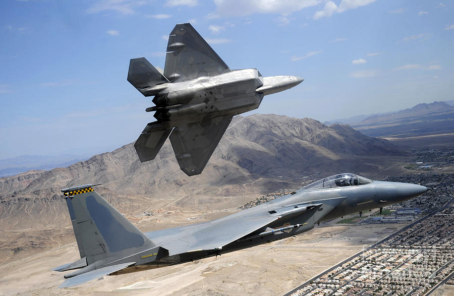 An F-22 Raptor Aircraft Peels Away Photograph by Stocktrek Images