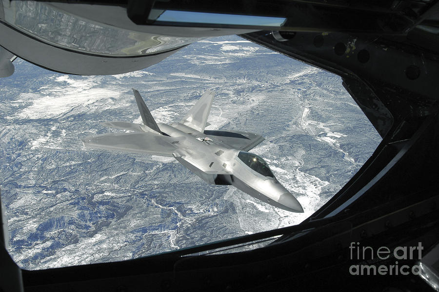 An F-22 Raptor Banks Away From A Kc-135 Photograph by Stocktrek Images