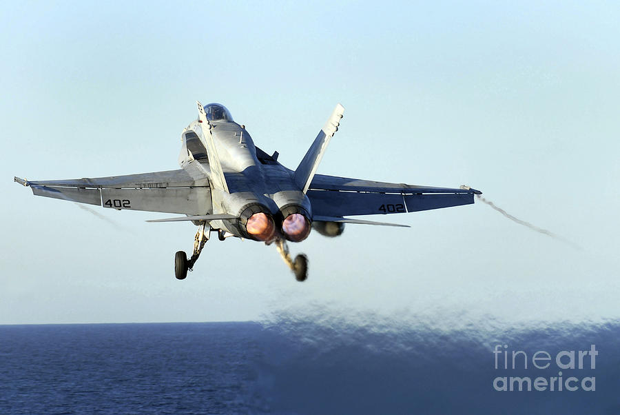 Airplane Photograph - An Fa-18c Hornet Launches by Stocktrek Images