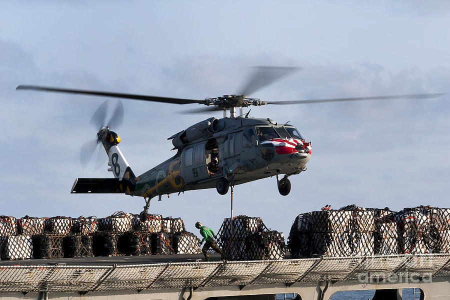 Transportation Photograph - An Mh-60s Sea Hawk Lifts Cargo by Stocktrek Images