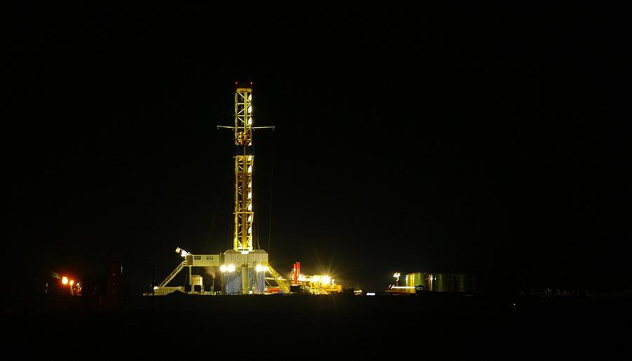 An Oil Rig At Night Photograph By Jeff Swan 