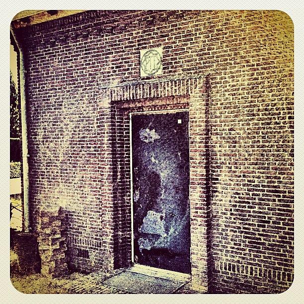 Vintage Photograph - An Old #building With Iron Door by Wilbert Claessens