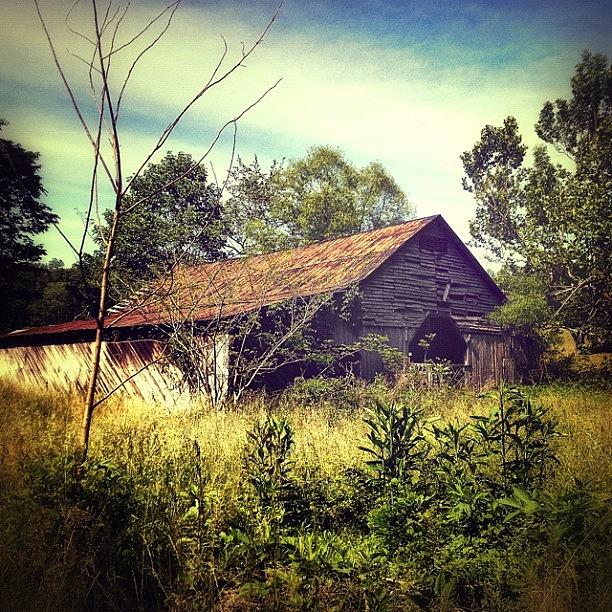 Barn Photograph - An Old Dilapidated Barn That Sits On by Karyn Teno
