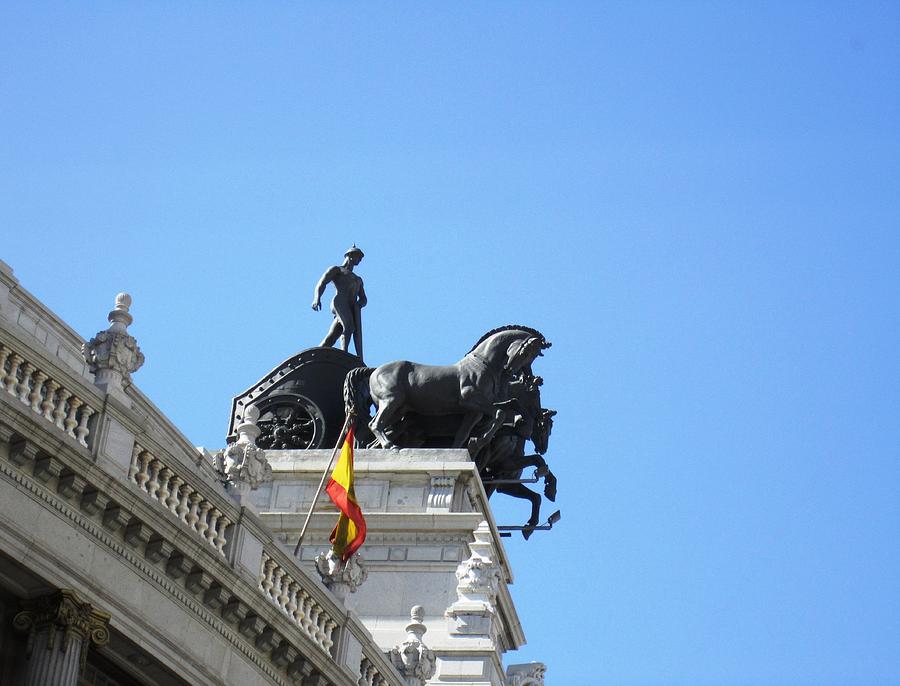 Ancient Horse and Buggy Statue and Spanish Flag in Madrid Spain Photograph by John Shiron