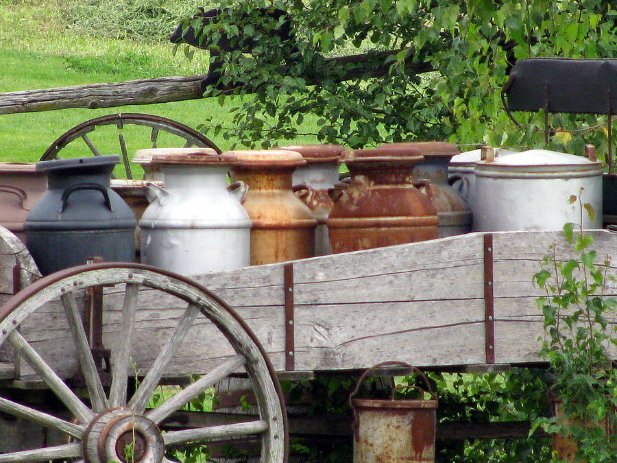 Old Wagon Wheels Photograph - Antique Milk Jugs by Corinna Garza