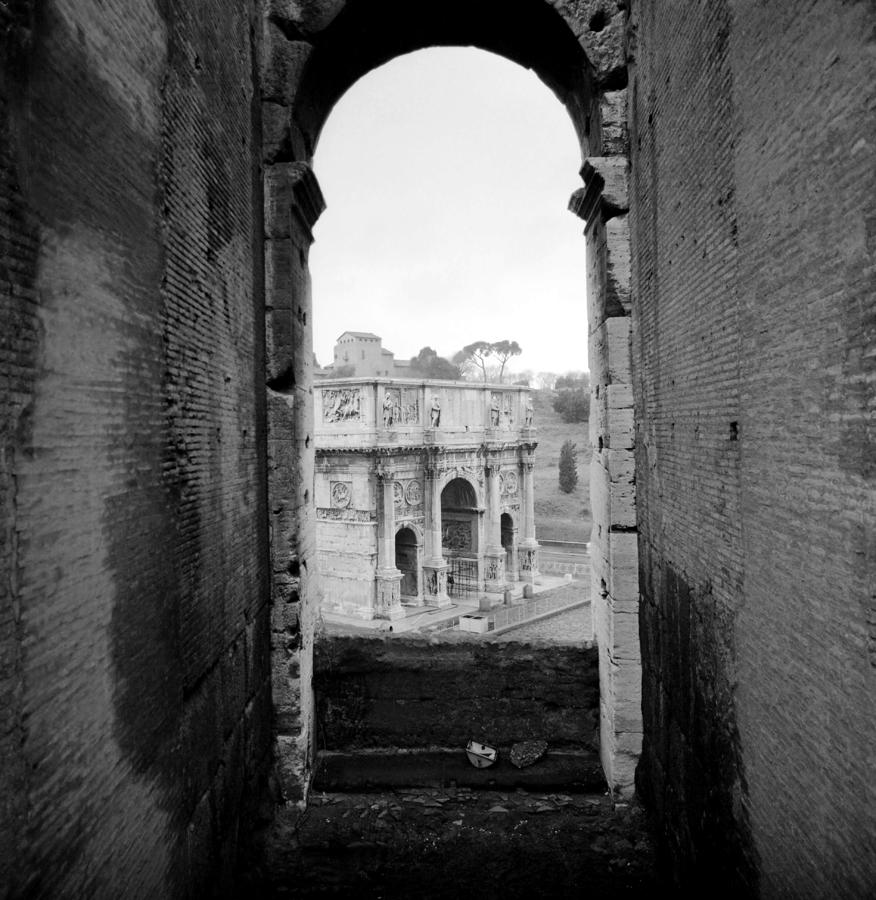 Arch of Constantine seen from the Colosseum Photograph by Emanuel Tanjala