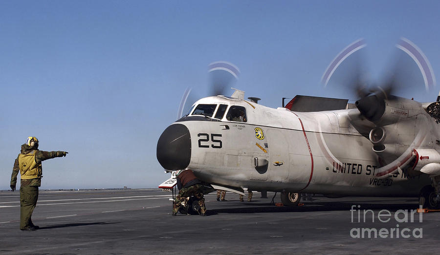 Airplane Photograph - Aviation Boatswain Mate Directs A C-2a by Stocktrek Images