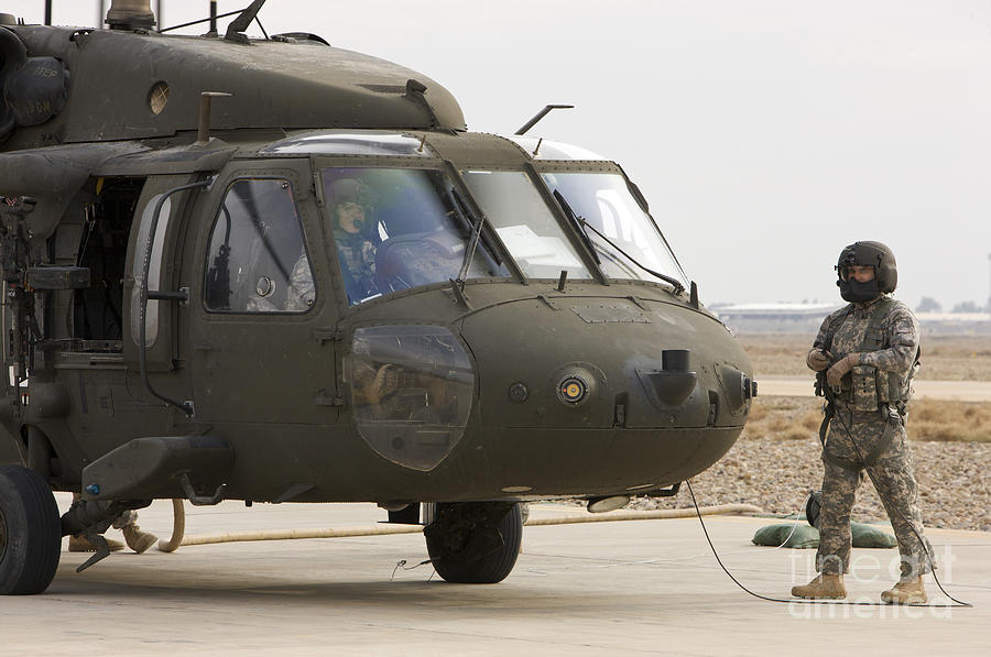 Balad, Iraq - A Uh-60l Black Hawk Lands Photograph by Terry Moore