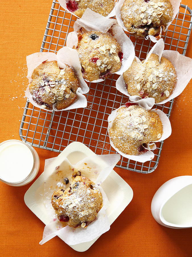 Berry Oat Muffins On Cooling Rack Photograph by Cultura/BRETT STEVENS