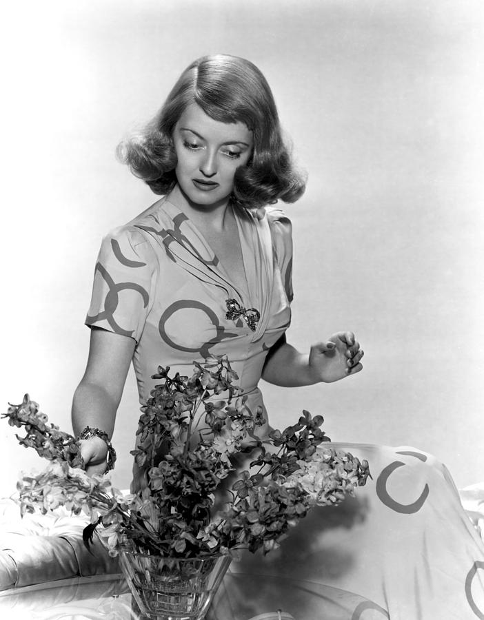 Bette Davis Arranging Flowers Photograph by Everett
