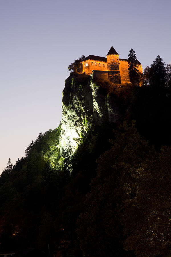 Bled castle lit up at night Photograph by Ian Middleton